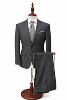 Gray suit with a tie on a wooden mannequin stand against a white background